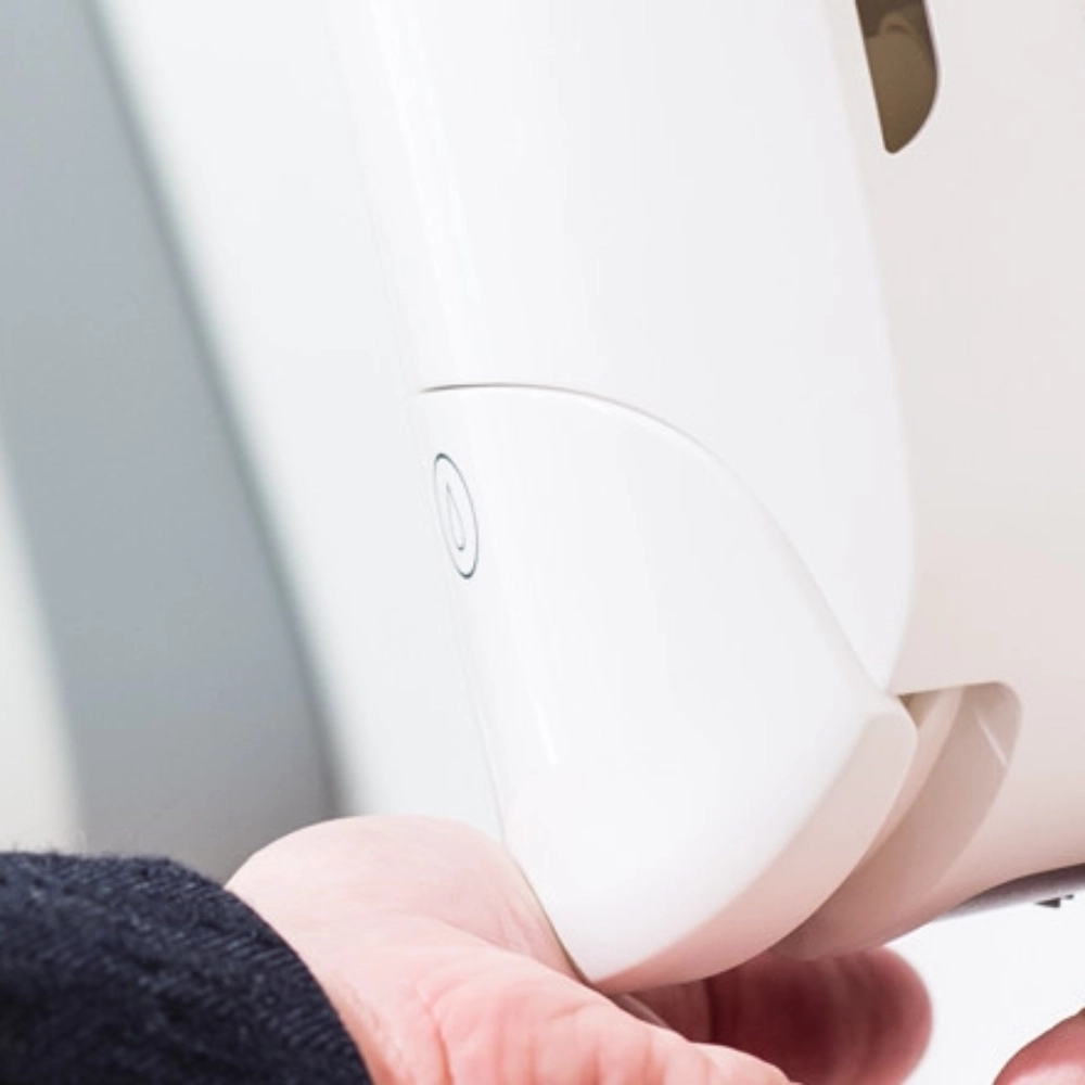hand pushing down manual soap dispenser 