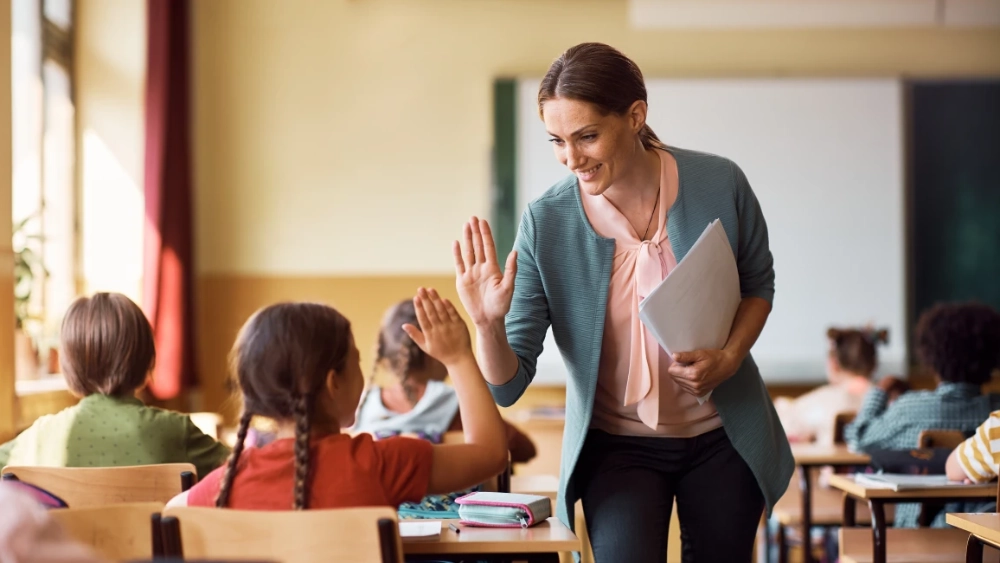 image-banner-stock-happy-teacher-and-schoolgirl-giving-high-five-1410336912.webp
