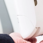hand pushing down manual soap dispenser 