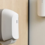 twin roll toilet paper dispenser next to other initial products in washroom
