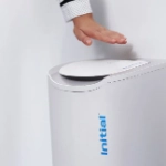 hand waving over no touch sanitary bin 