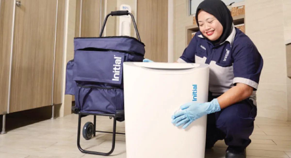 Technician with sanitary bin