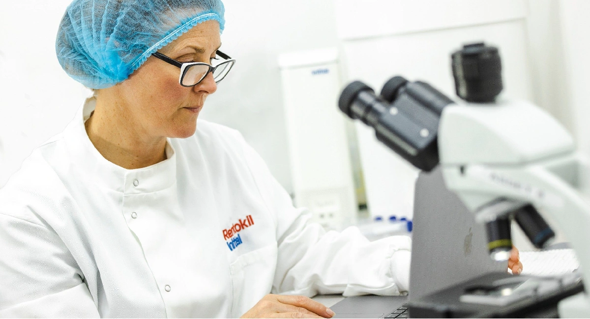 Scientist looking into microscope
