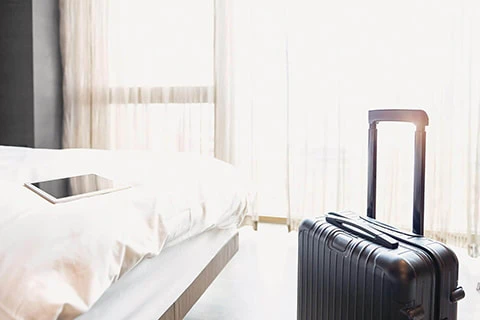 hotel room unpacked luggage