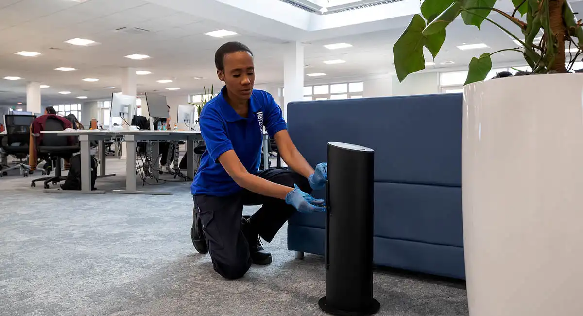 Colleague servicing scent product in office