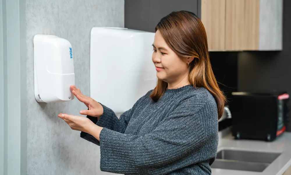 a woman using hand sanitiser